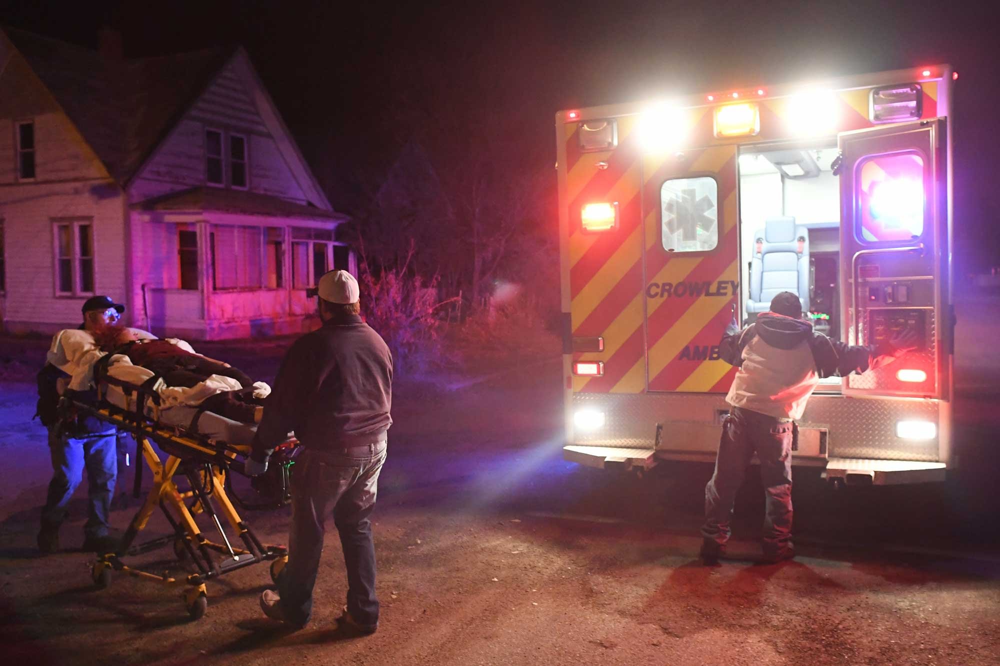 Paramedics loading a patient into an emergency ambulance